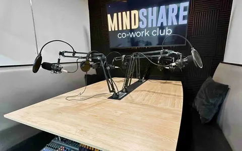 Mindshare Co-work Club podcast studio with microphones and a recording desk